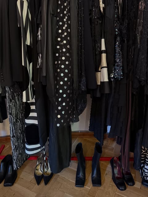 Dark tailoring and patterned vintage clothing on a rail