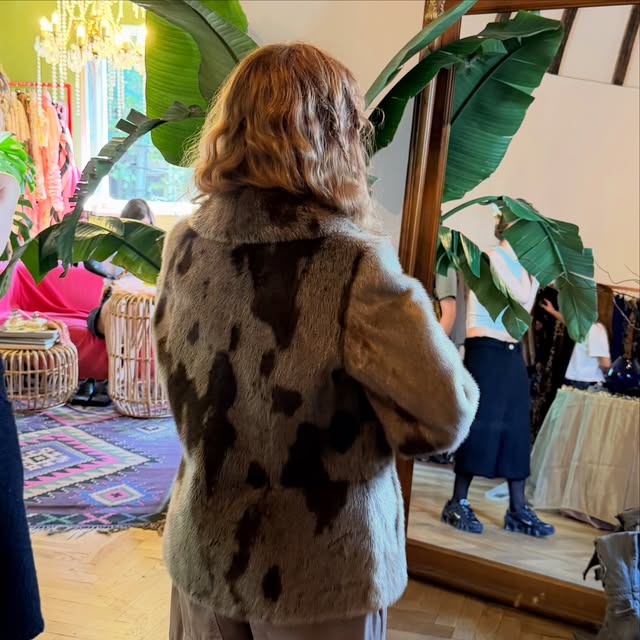 A shopper wearing a patterned statement coat